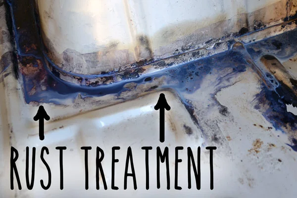 Applying rust treatment to the van floor